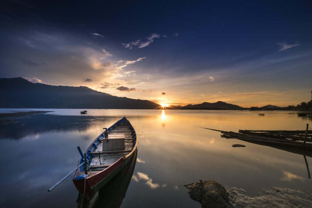 Vietnam, sea with boats floating and sunrise